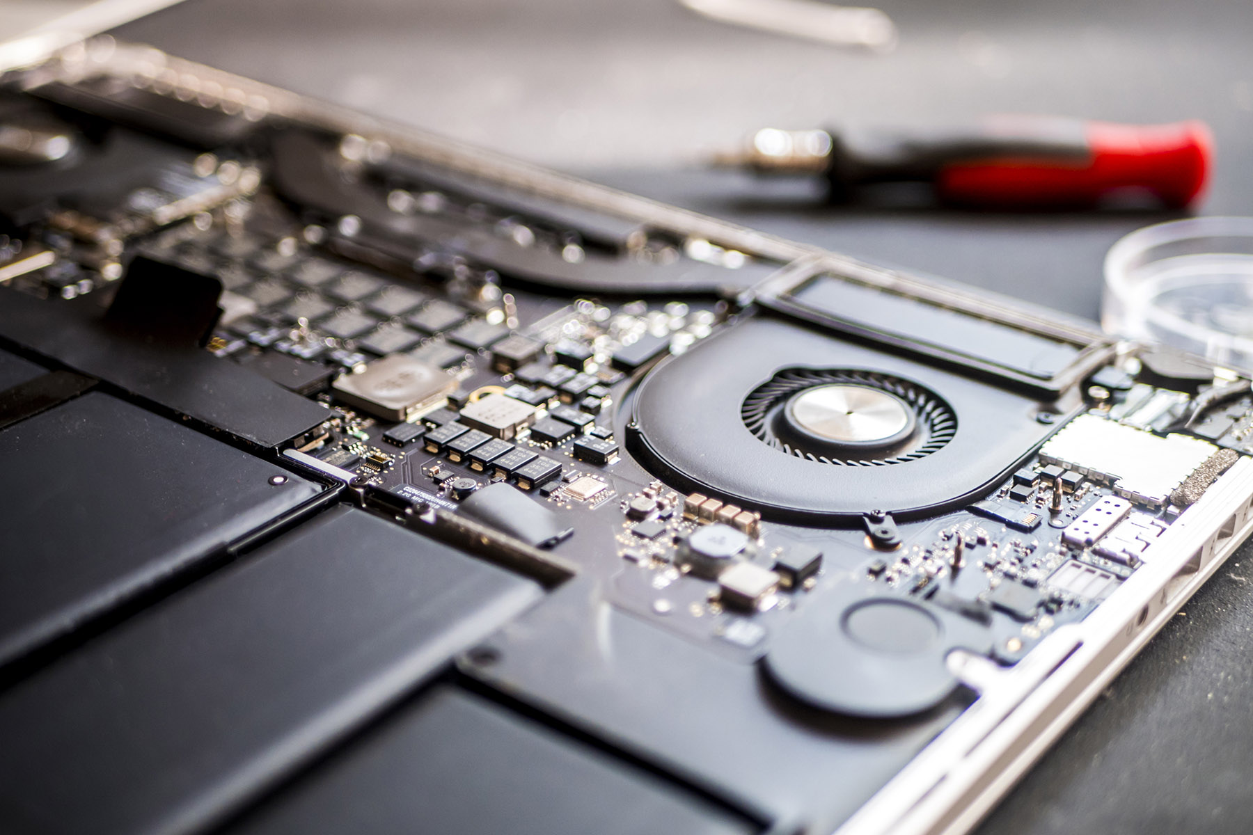 close up disassembled laptop cooler and mother board in the workshop on table